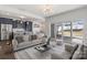 Bright, open-concept living room with kitchen, stainless steel appliances, and sliding doors to the patio at 439 Newfound Hollow Dr, Charlotte, NC 28214