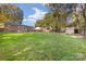 Large backyard with a shed, lush green lawn, and mature trees, creating a serene outdoor space at 4635 General Pershing Dr, Charlotte, NC 28209