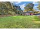 Sprawling backyard showcasing lush green grass and a brick home, perfect for outdoor activities and relaxation at 4635 General Pershing Dr, Charlotte, NC 28209