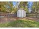 Well-maintained backyard features a useful storage shed surrounded by a wooden fence and lush green lawn at 4635 General Pershing Dr, Charlotte, NC 28209