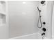 Modern bathroom featuring white subway tiles, sleek black fixtures, and a shower-over-tub design at 4635 General Pershing Dr, Charlotte, NC 28209