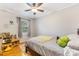 Bright bedroom with hardwood floors, a ceiling fan, and a large window at 4635 General Pershing Dr, Charlotte, NC 28209