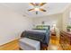 Bedroom with hardwood floors, ceiling fan, and neutral color palette at 4635 General Pershing Dr, Charlotte, NC 28209