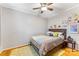 Cozy bedroom featuring hardwood floors, a ceiling fan, and neutral decor at 4635 General Pershing Dr, Charlotte, NC 28209