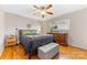 Bedroom with hardwood floors, ceiling fan, and neutral color palette at 4635 General Pershing Dr, Charlotte, NC 28209
