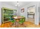 Bright dining area features hardwood floors, green chairs and hutch, and natural light at 4635 General Pershing Dr, Charlotte, NC 28209