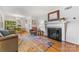 Cozy living room with a fireplace, hardwood floors, and bright windows at 4635 General Pershing Dr, Charlotte, NC 28209