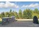 View of the large, grassy backyard featuring a built-in outdoor kitchen with a grill at 5004 Oakmere Rd, Waxhaw, NC 28173
