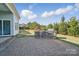 Spacious backyard with stone patio, outdoor kitchen, and lush landscaping at 5004 Oakmere Rd, Waxhaw, NC 28173