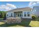 Backyard showcases a covered patio and a built-in stone outdoor kitchen area at 5004 Oakmere Rd, Waxhaw, NC 28173