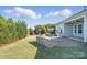 A spacious backyard featuring a built-in outdoor kitchen and lush landscaping at 5004 Oakmere Rd, Waxhaw, NC 28173