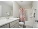 Bathroom featuring a vanity with white countertops, a shower-tub combination and white cabinets at 5004 Oakmere Rd, Waxhaw, NC 28173