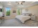 A spacious main bedroom with trey ceiling, ensuite bath, large windows, and modern furnishings at 5004 Oakmere Rd, Waxhaw, NC 28173