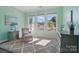 Bright room with three windows, a comfortable armchair and a patterned rug at 5004 Oakmere Rd, Waxhaw, NC 28173