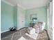 Bright bedroom features a plush chair, neutral carpet, and a window at 5004 Oakmere Rd, Waxhaw, NC 28173