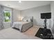 Bedroom featuring a large window, a ceiling fan, exercise bike and a comfortable queen bed at 5004 Oakmere Rd, Waxhaw, NC 28173