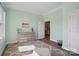 A light-filled room with an area rug, a neutral colored dresser and a small seating area at 5004 Oakmere Rd, Waxhaw, NC 28173