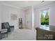 Bedroom features a grey chair, neutral carpet, a window, and a closet at 5004 Oakmere Rd, Waxhaw, NC 28173