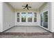 View of the covered patio with ceiling fan and sliding glass doors overlooking the yard at 5004 Oakmere Rd, Waxhaw, NC 28173
