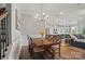 Dining room with wood floors, trim and stairs, kitchen and Gathering room nearby at 5004 Oakmere Rd, Waxhaw, NC 28173
