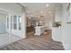 An open kitchen and living area with hardwood flooring and an eat-in island at 5004 Oakmere Rd, Waxhaw, NC 28173
