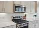 A modern kitchen featuring stainless steel appliances and white subway tile backsplash at 5004 Oakmere Rd, Waxhaw, NC 28173