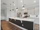 Open concept kitchen featuring a large island with stainless sink and modern pendant lights at 5004 Oakmere Rd, Waxhaw, NC 28173