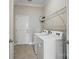 Well-organized laundry room with a washer, dryer and a wire rack shelf at 5004 Oakmere Rd, Waxhaw, NC 28173