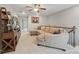 Upstairs living room featuring a sectional sofa, ceiling fan, and built-in shelving at 5004 Oakmere Rd, Waxhaw, NC 28173
