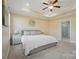 Bright main bedroom features a tray ceiling, ceiling fan and ensuite bathroom with tile floors at 5004 Oakmere Rd, Waxhaw, NC 28173