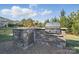Stone outdoor kitchen with grill and food prep area, perfect for entertaining at 5004 Oakmere Rd, Waxhaw, NC 28173