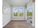 A versatile room with hardwood floors, natural light, and sliding glass doors at 5004 Oakmere Rd, Waxhaw, NC 28173