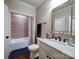 Bathroom featuring a single sink vanity with decorative mirror and tiled shower at 508 Summerfield Pl, Belmont, NC 28012