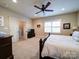 Comfortable bedroom with carpet and a ceiling fan, adjacent to another room at 508 Summerfield Pl, Belmont, NC 28012