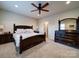 Bedroom showcasing a large bed, dark wood furniture, carpet flooring, and a bright window with natural light at 508 Summerfield Pl, Belmont, NC 28012