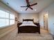 Serene bedroom with a dark wood bed, bedside tables, plantation shutters, and soft carpet at 508 Summerfield Pl, Belmont, NC 28012