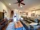 Inviting living room with a large leather sofa, wood coffee table, connecting to a staircase and a modern kitchen at 508 Summerfield Pl, Belmont, NC 28012
