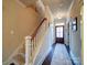 Staircase with carpeted steps and a wooden handrail leads to an entry door with sidelights at 508 Summerfield Pl, Belmont, NC 28012