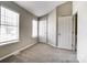 This bedroom features a large window providing natural light and neutral walls at 6210 Windsor Gate Ln, Charlotte, NC 28215