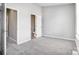 This bedroom is open to a bathroom with gray walls and neutral carpet at 6210 Windsor Gate Ln, Charlotte, NC 28215