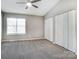 Spacious bedroom with neutral colors, a ceiling fan, and plenty of closet space at 6210 Windsor Gate Ln, Charlotte, NC 28215