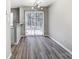 Dining space with sliding glass doors and contemporary lighting fixture at 6210 Windsor Gate Ln, Charlotte, NC 28215