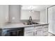Kitchen featuring a stainless steel sink, updated cabinets, and a modern lighting fixture at 6210 Windsor Gate Ln, Charlotte, NC 28215