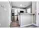 Well-lit kitchen featuring stainless steel appliances, white cabinets, and a breakfast bar at 6210 Windsor Gate Ln, Charlotte, NC 28215