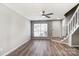 Bright living room featuring hardwood floors, large windows, and a modern ceiling fan at 6210 Windsor Gate Ln, Charlotte, NC 28215