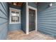 Inviting condo doorway featuring a wood porch, classic trim, and dark front door at 623 Olmsted Park Pl # D, Charlotte, NC 28203