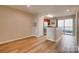 Open-concept kitchen with stainless steel appliances and a breakfast bar with a view of a balcony at 623 Olmsted Park Pl # D, Charlotte, NC 28203