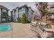 Community poolside grilling area with stainless steel grills and surrounding apartments, ideal for outdoor entertaining at 623 Olmsted Park Pl # D, Charlotte, NC 28203