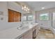 Bathroom featuring a double sink vanity with large mirror, tiled walls, and a shower-tub combo at 6285 Nc 16 N Hwy, Taylorsville, NC 28681