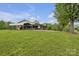 Ranch style home with car port and beautiful lawn surrounded by lush green trees and mountain views at 6285 Nc 16 N Hwy, Taylorsville, NC 28681